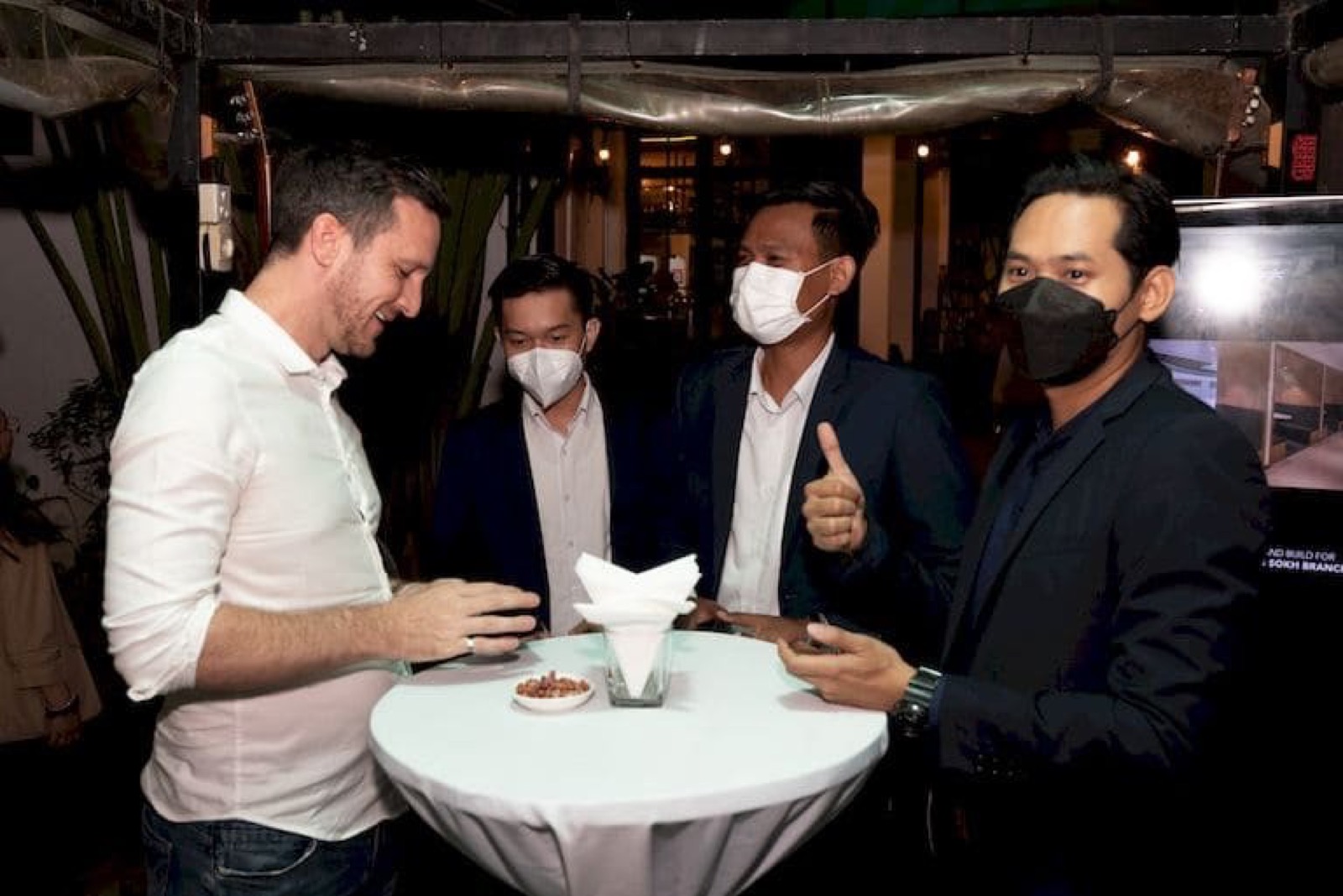 Members at a high table at an AmCham Cambodia networking evening
